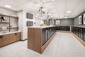 A long hallway with a patterned floor and a row of lockers on the right.